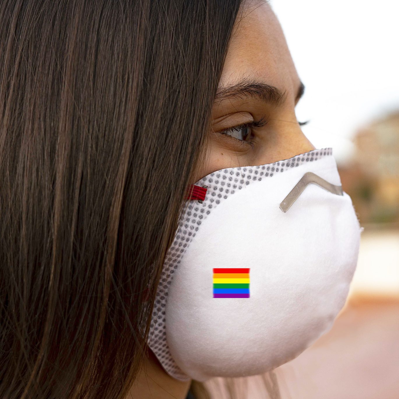 Person wearing PPE mask with pride flag